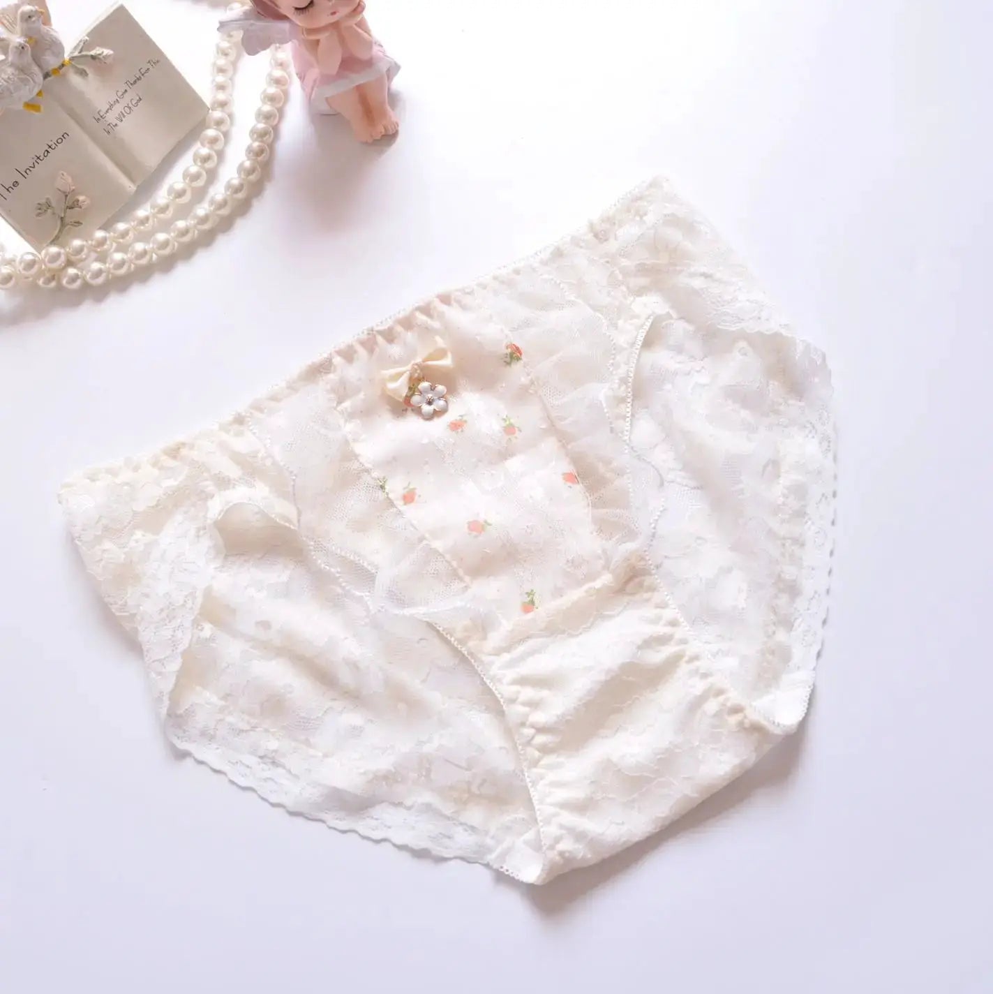 Panties for women in ivory white cotton lace with floral embroidery and bow detail