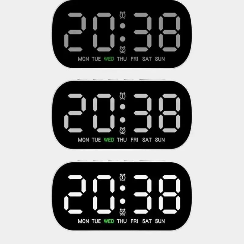 Digital alarm clocks, three black LED displays with white digits, showing 24/12-hour time and weekday indicators.