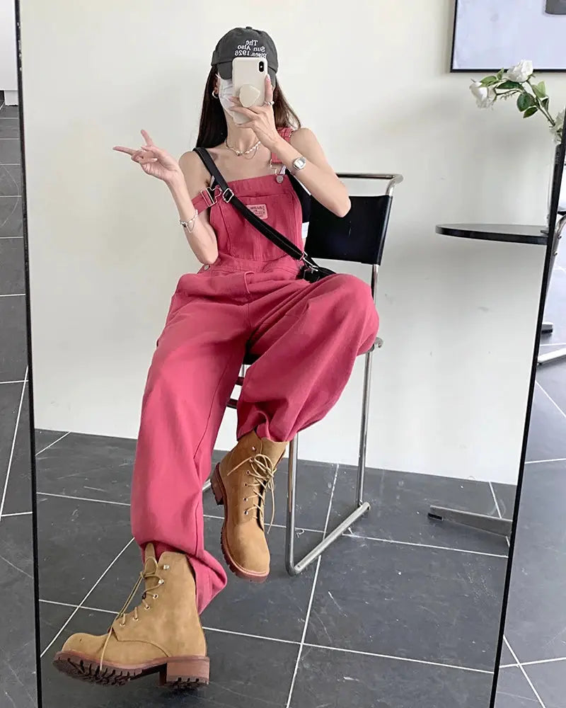 Pink women's denim overalls with a loose wide-leg silhouette for casual summer style