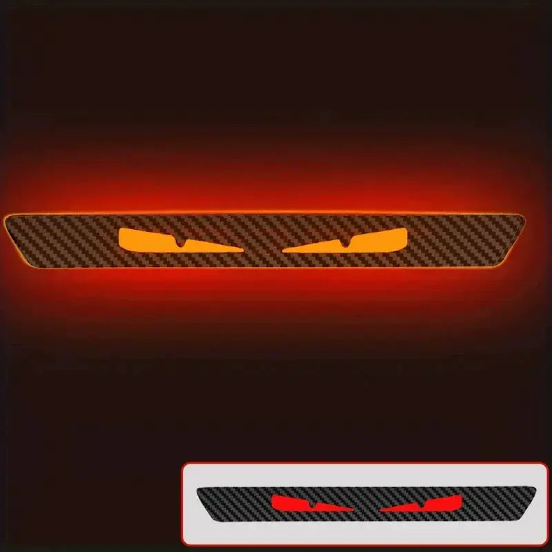 Monster Eyes car rear light sticker with carbon fiber pattern and orange eyes; inset shows red-eye variant