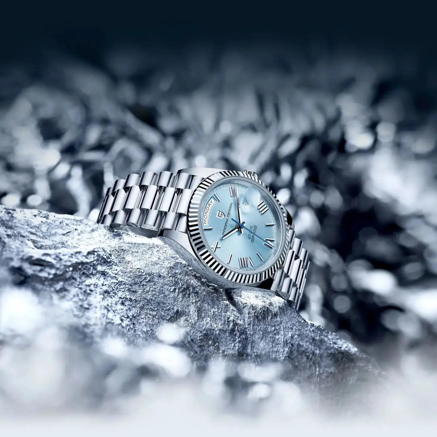 PAGANI DESIGN stainless steel men's watch with blue dial, fluted bezel, day indicator, silver bracelet