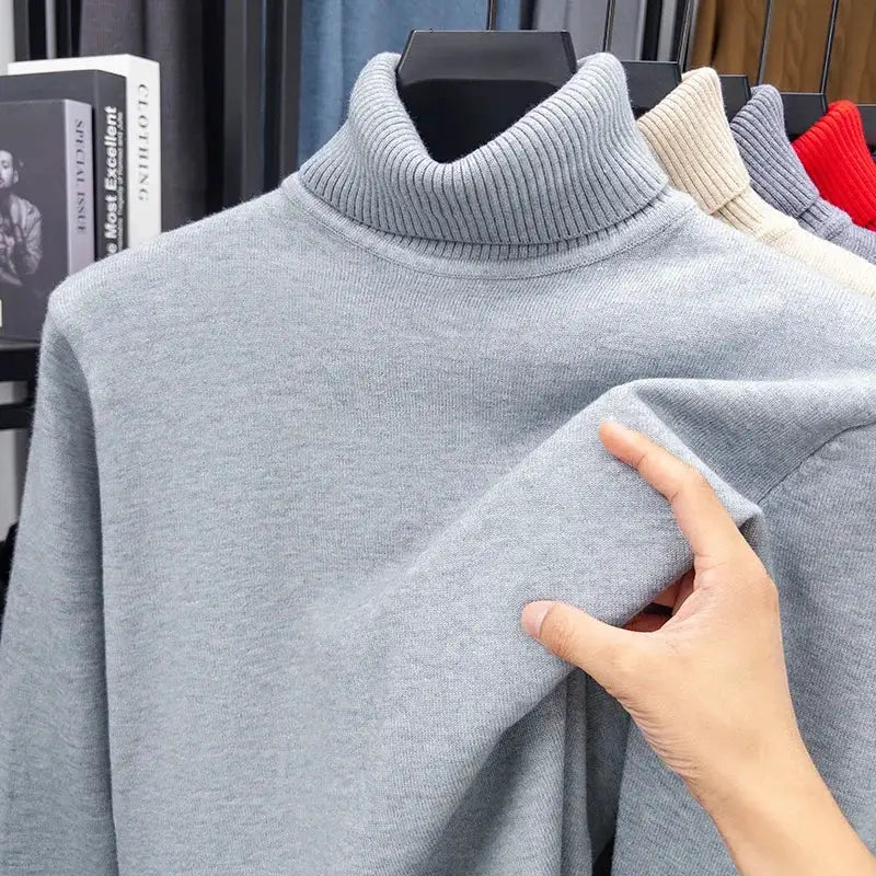 Men's light gray knitted turtleneck sweater on display; ribbed collar and soft knit fabric