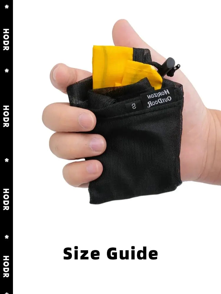 HODR mesh stuff sack held in hand; black drawstring pouch with yellow contents.