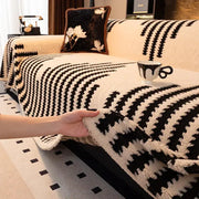 Thick warm jacquard fleece sofa throw blanket in black and cream on living room couch