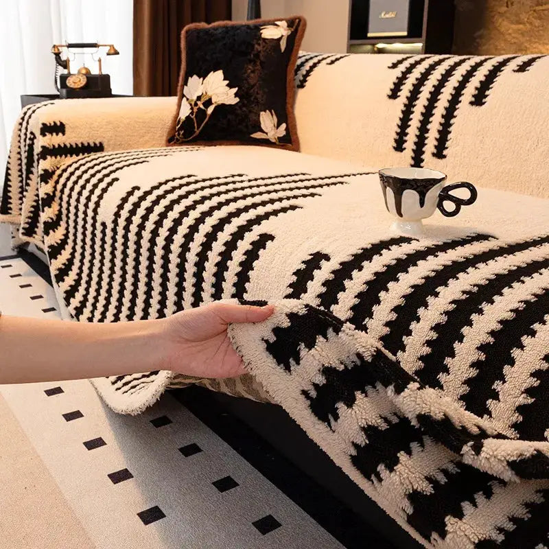 Thick warm jacquard fleece sofa throw blanket in black and cream on living room couch