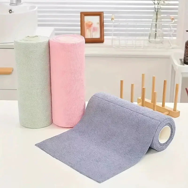 Microfiber cleaning towels set: three pastel rolls in gray, pink, mint with a blue-gray unrolled sheet