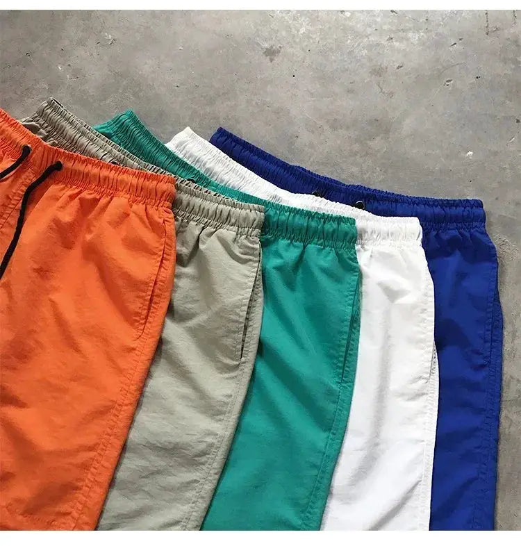 Simples Market men's swim shorts set in seven colorways with elastic waistbands and drawstrings.