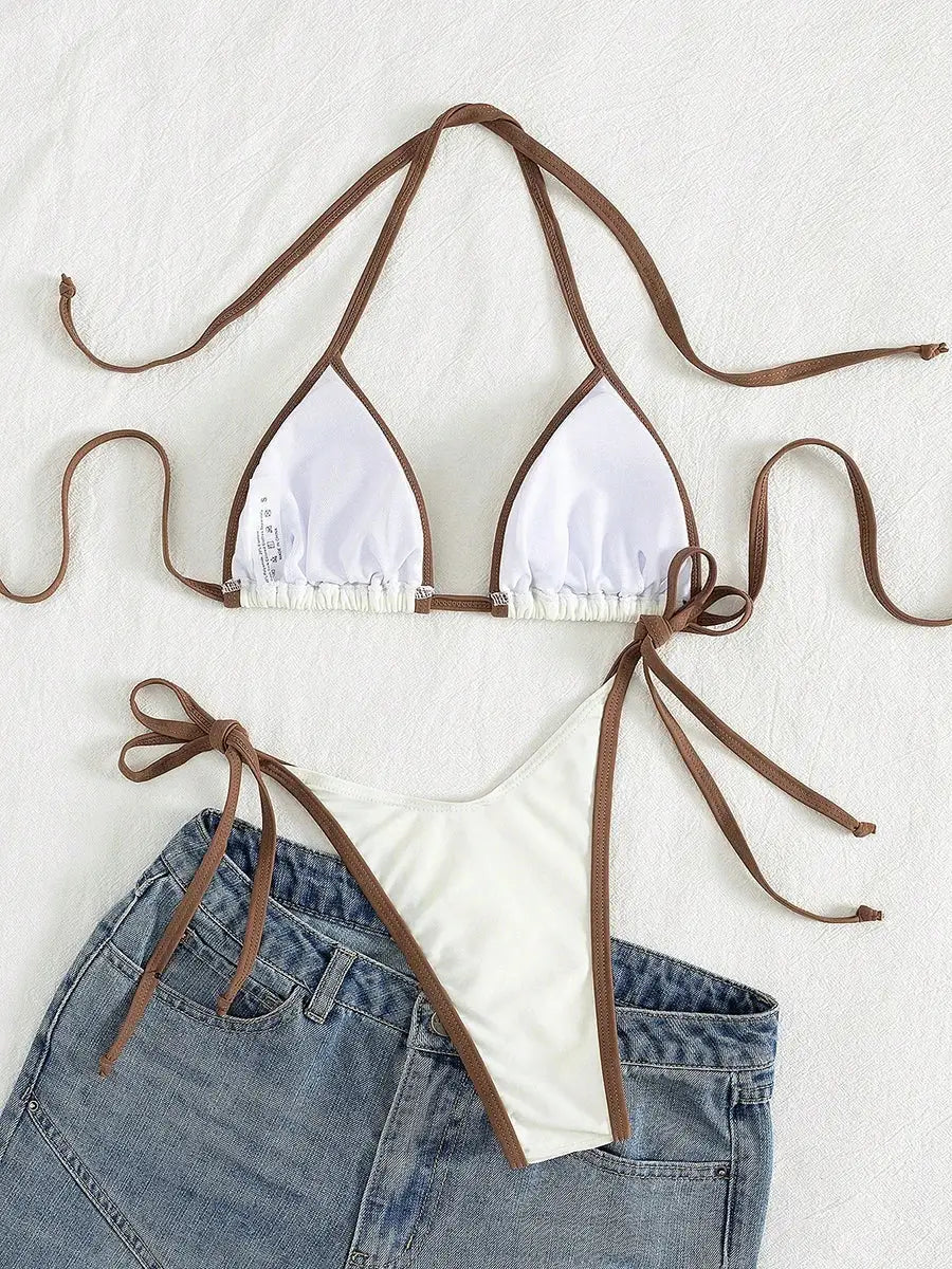 Two-piece white micro bikini with brown trim, triangle top and tie-side bottoms