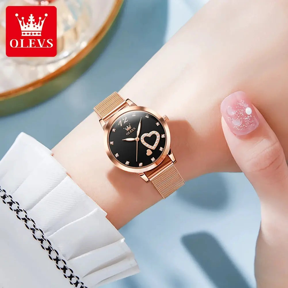 OLEVS women's quartz watch with rose-gold mesh strap, black dial, heart-shaped crystal outline.