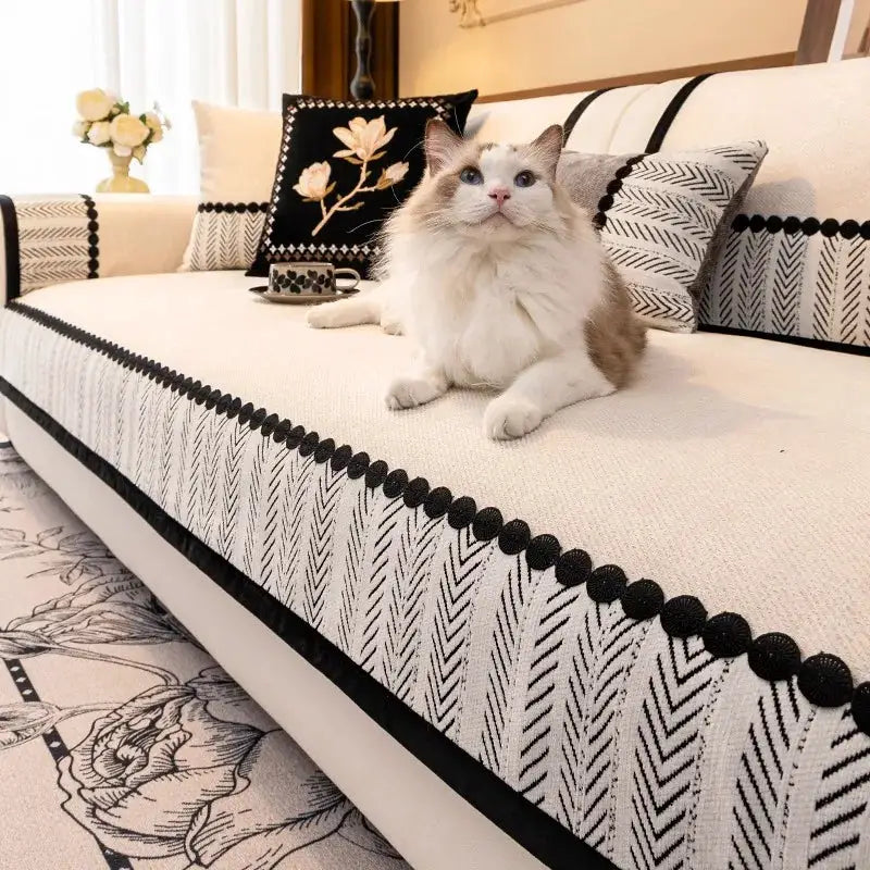 Sofa cover by Simples Market: contrast hem twill chenille in cream with black pom-pom edge on sofa