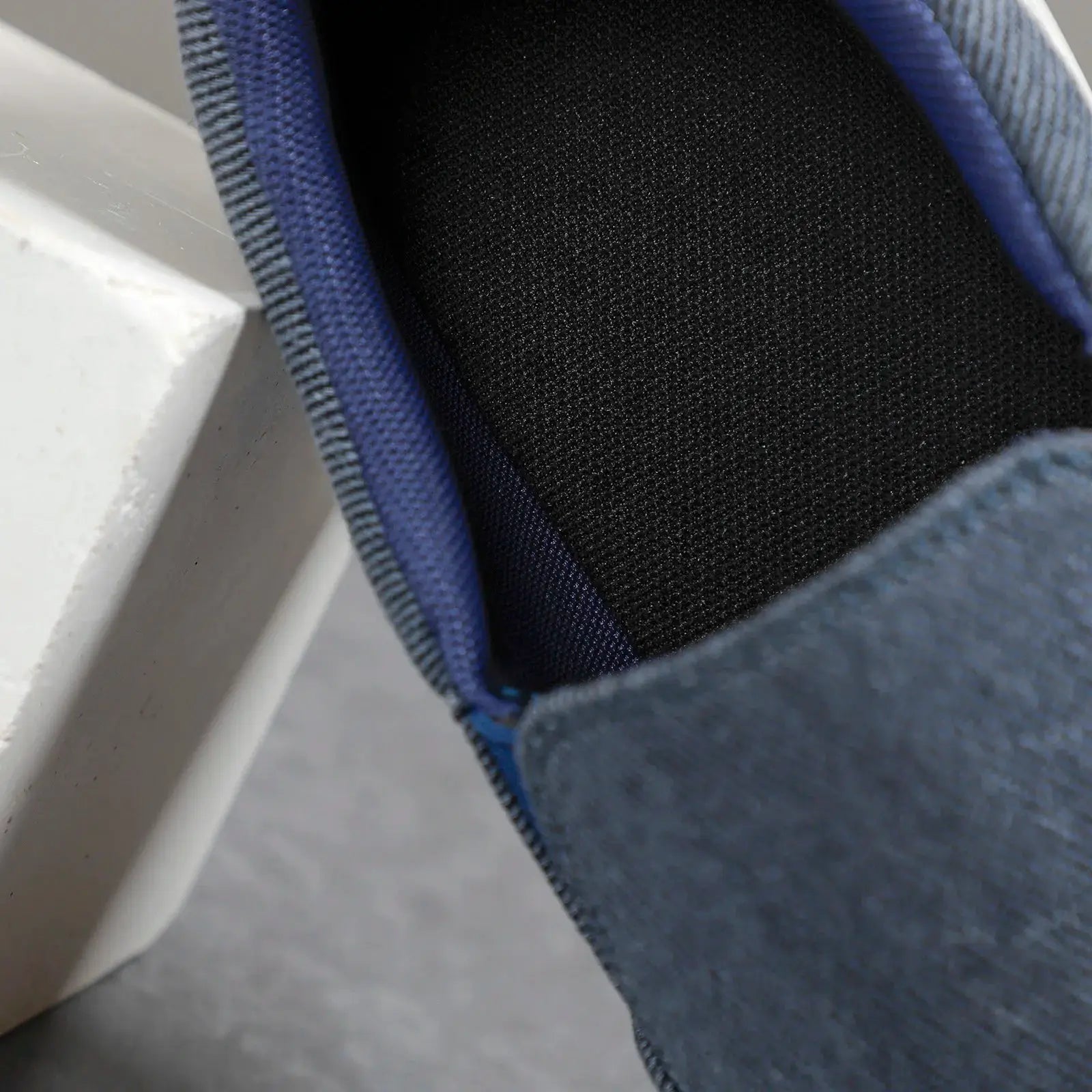 Men's blue canvas slip-on sneakers with breathable black lining