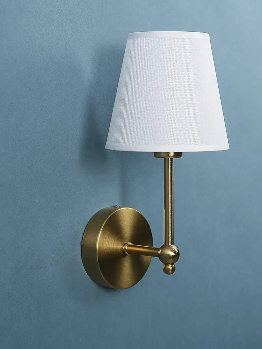 American retro wall lamp with brass finish and white fabric shade, wall-mounted.
