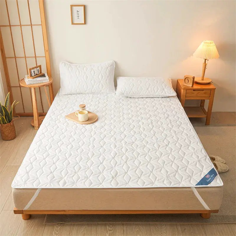 Waterproof white quilted mattress protector with elastic corner straps, fits up to 40 cm deep