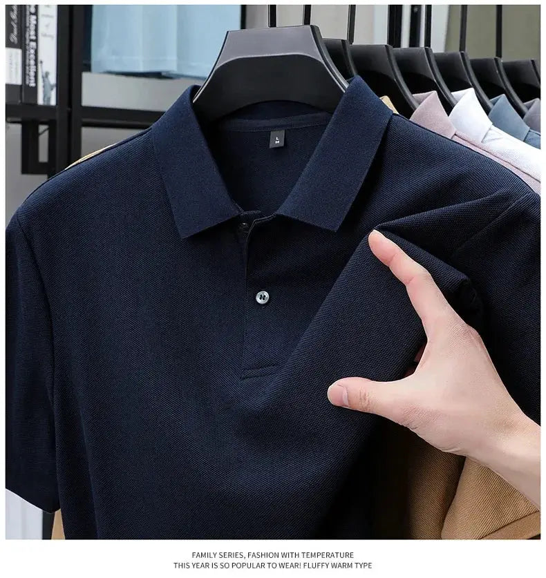 Men's navy cotton polo shirt on a hanger; textured pique knit, casual-sport style.