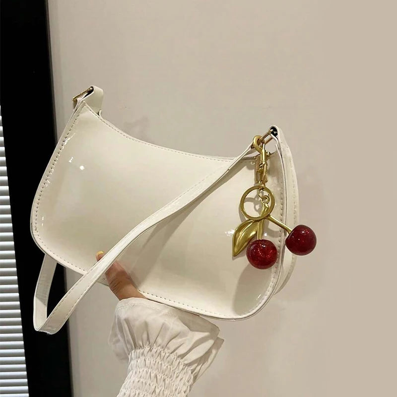 Women's white PU leather shoulder bag with cherry pendant charm, casual handbag