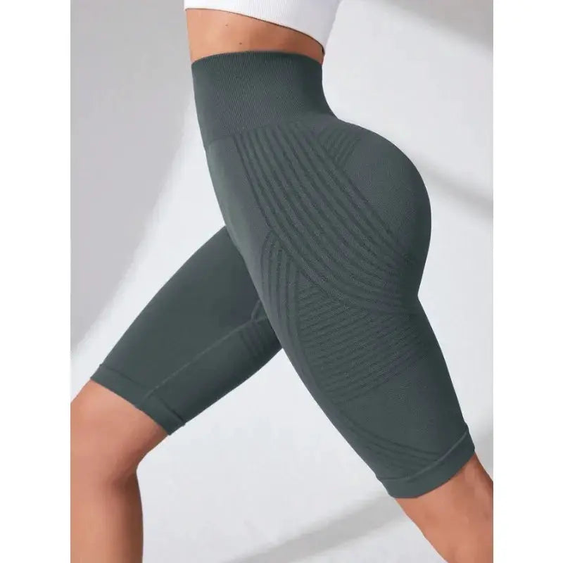 High-waisted seamless yoga shorts in dark gray-green knit, knee-length with hip-lift design