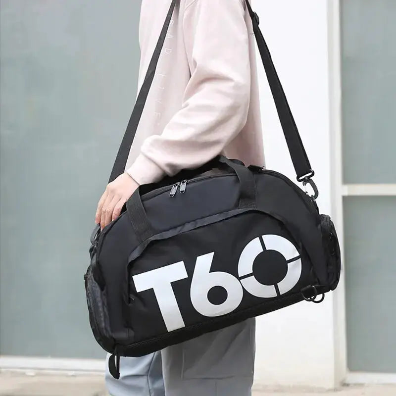 Black duffel gym bag with large white T60 logo, adjustable shoulder strap and carry handles.