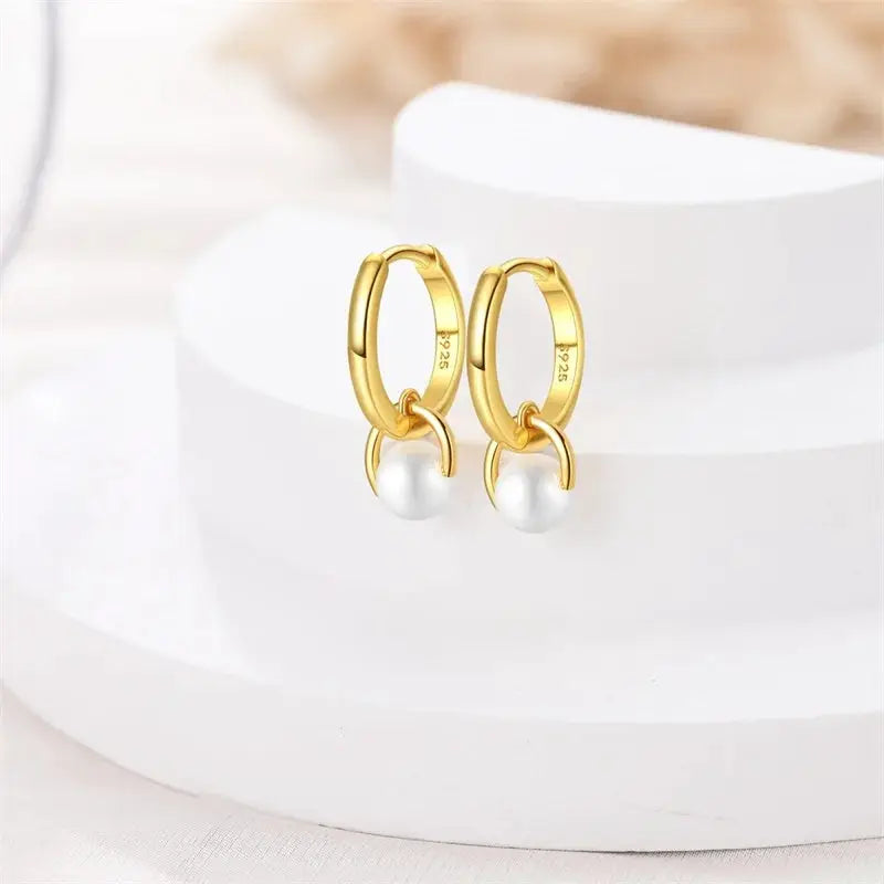 Gold-tone hoop earrings with dangling white pearl drops for women, pair