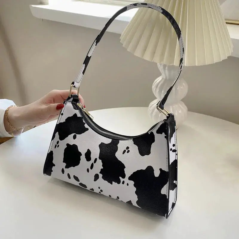 Cow-print PU leather shoulder bag with zebra-pattern top handle