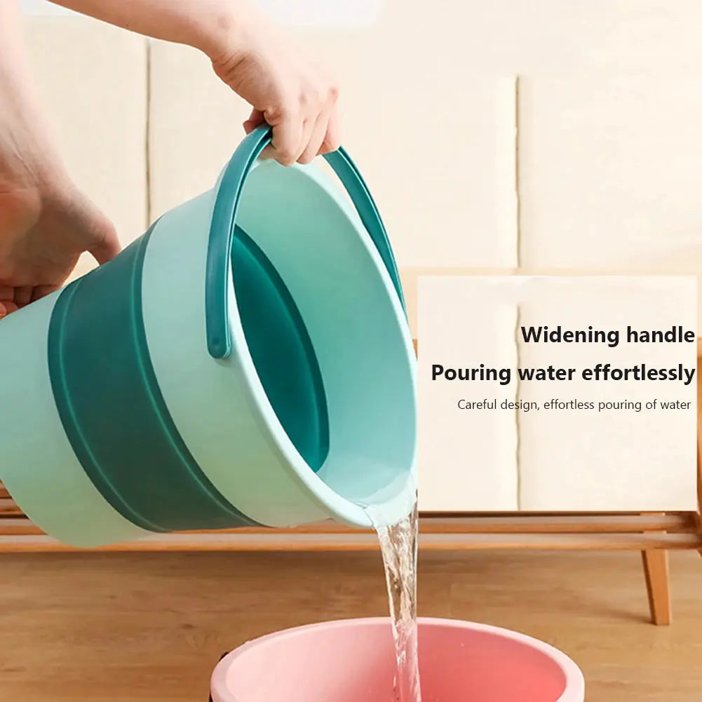 Folding silicone bucket with teal handle pouring water into a pink basin