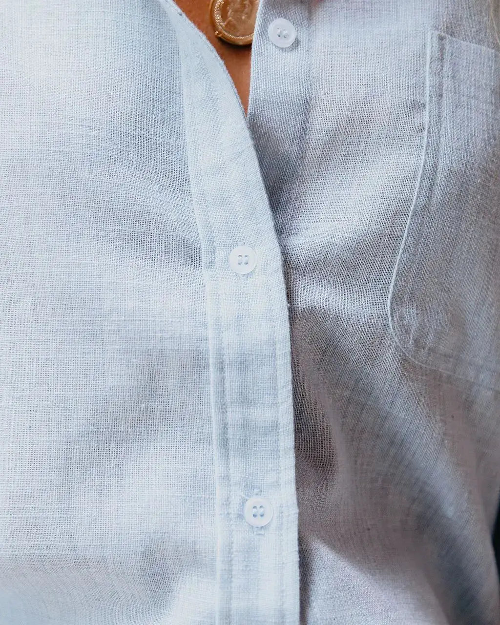 Women's light blue linen-cotton button-up blouse, loose fit with long sleeves and chest pocket