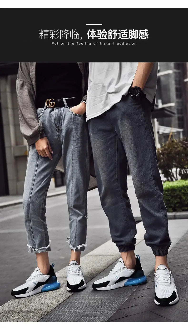 Men's sneakers with breathable mesh, white upper and blue sole, two pairs shown with rolled jeans
