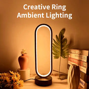 Bedroom ring night lamp, black oval LED dimmable ambient light with three color options.