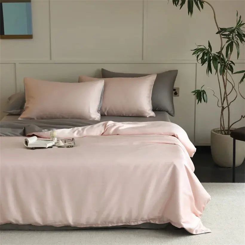 Mulberry silk bedding set by Simples Market in pink with duvet cover and pillowcases on a bed