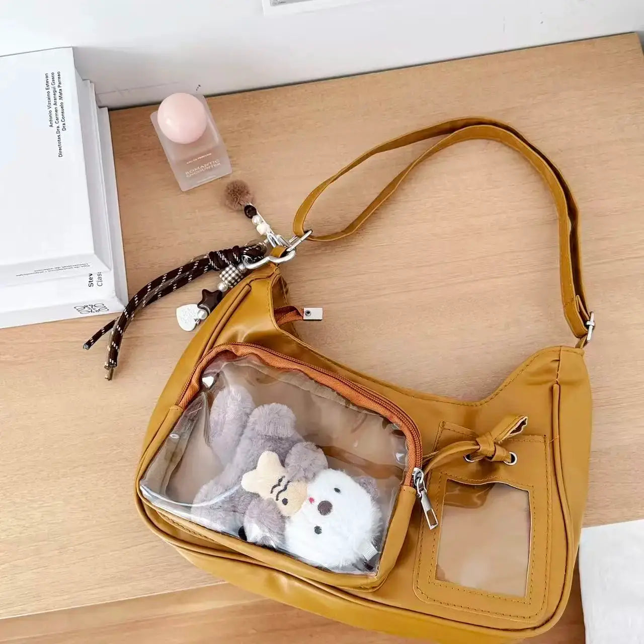 Shoulder bag, mustard yellow Y2K Harajuku ita bag with a transparent front window showing plush toys, includes crossbody strap.