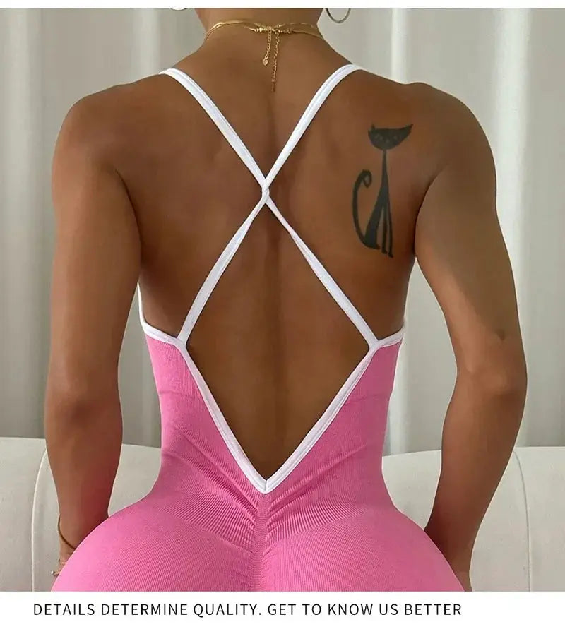 Women seamless ribbed pink color-block jumpsuit with white cross-back straps.