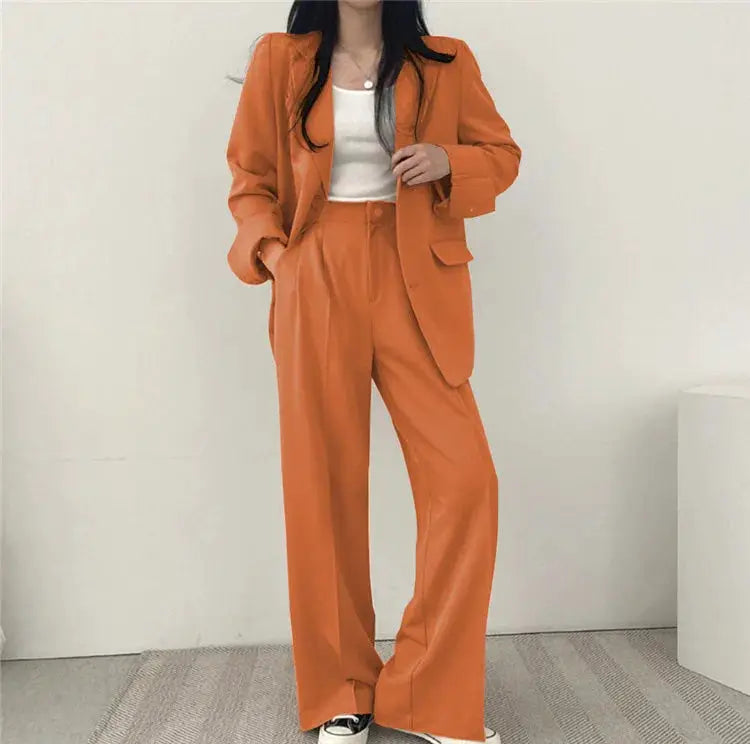 Simples Market Women's orange 2-piece blazer pant set with long sleeves and wide-leg pants.