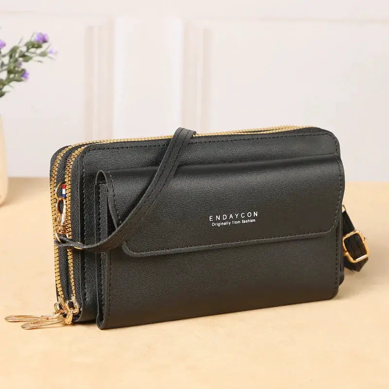 Crossbody bag Endaycon, black faux leather with double zippers, gold-tone hardware, adjustable strap