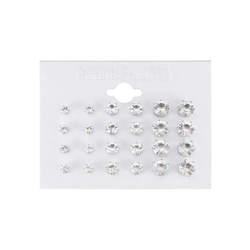 12-pair white crystal stud earrings set in varying sizes by Simples Market