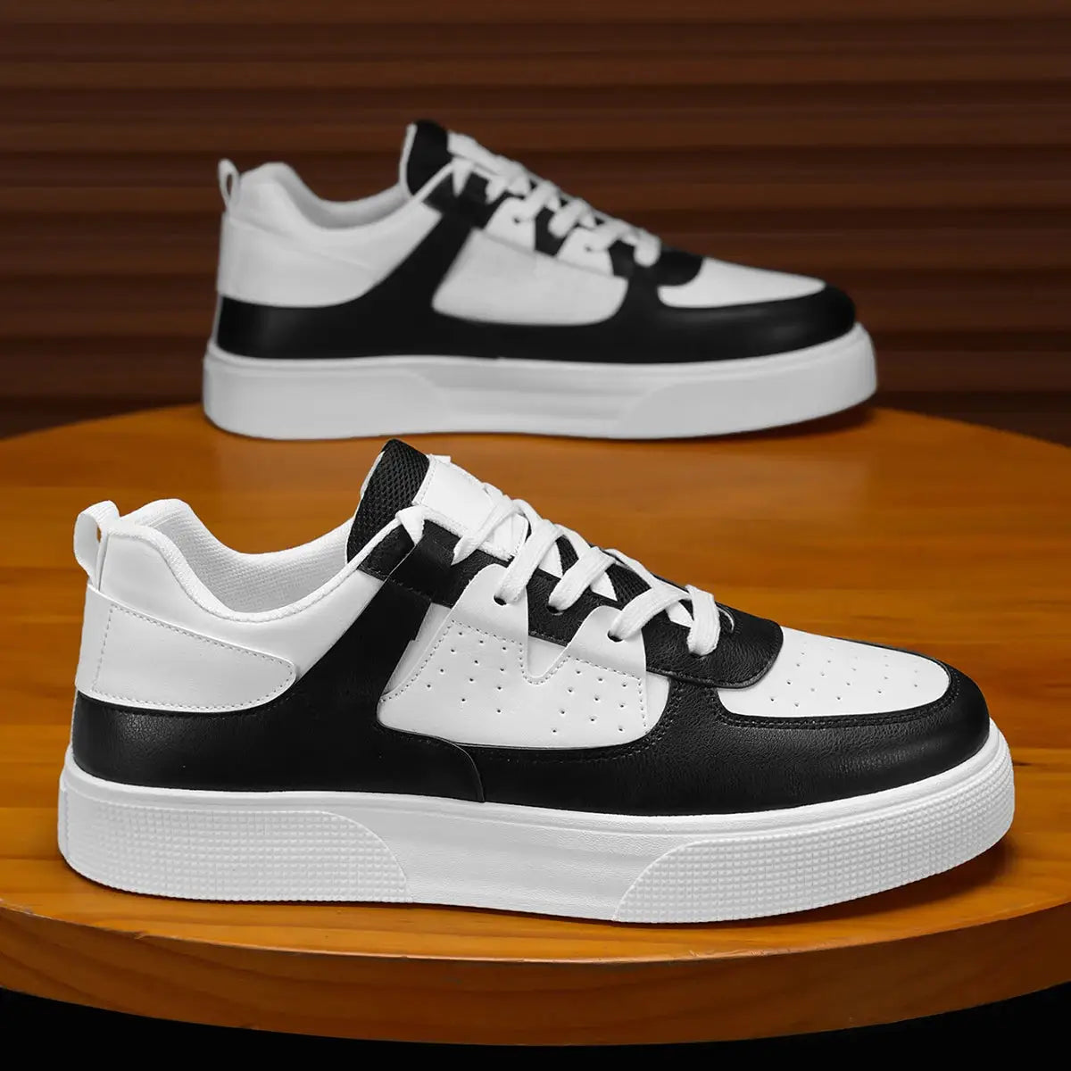 Men's casual sports shoes, black and white, lightweight minimalist sneakers, 2 pairs on a wooden table