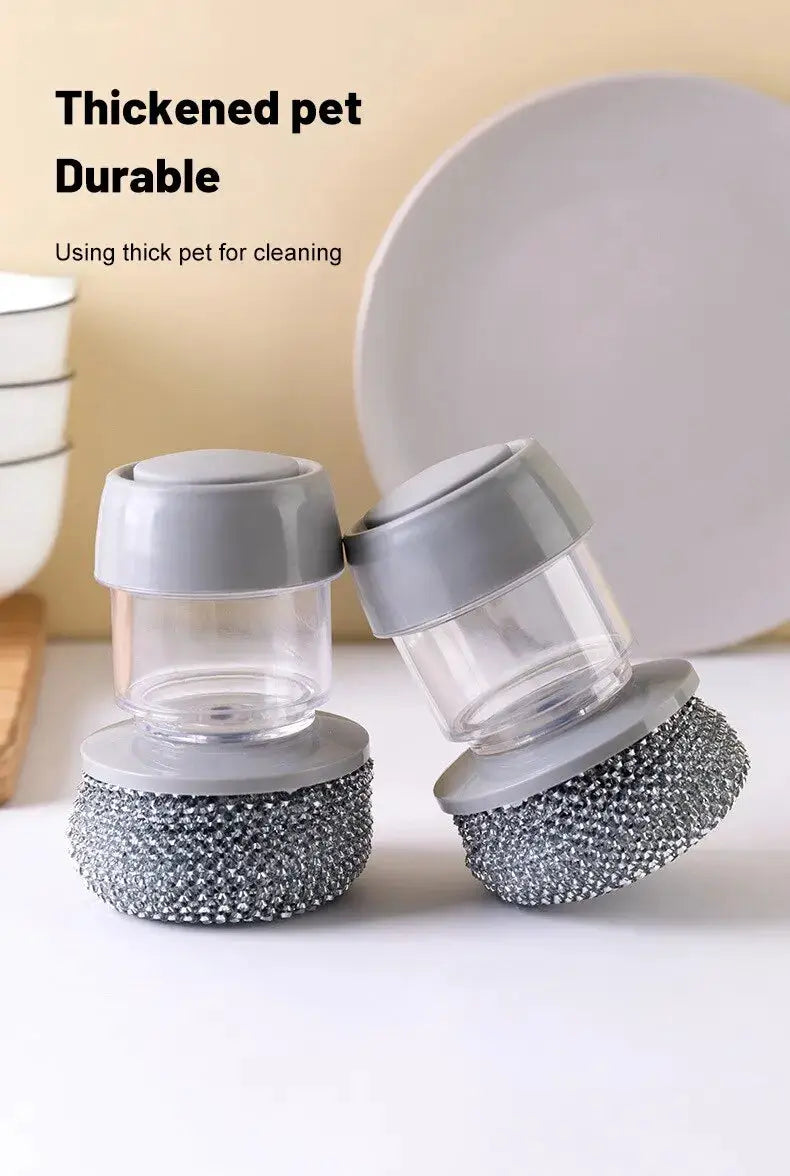 Two portable soap-dispensing dish scrubber tools with clear reservoirs, gray caps, and metal mesh scrubbing bases.
