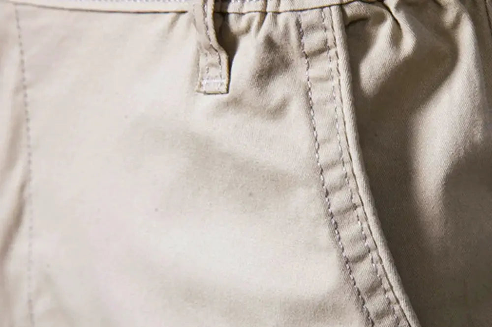 Men's beige 100% cotton solid shorts with elastic waist.