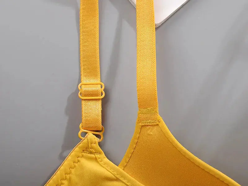 Women seamless yellow bra with adjustable straps; close-up of strap rings and cup edge