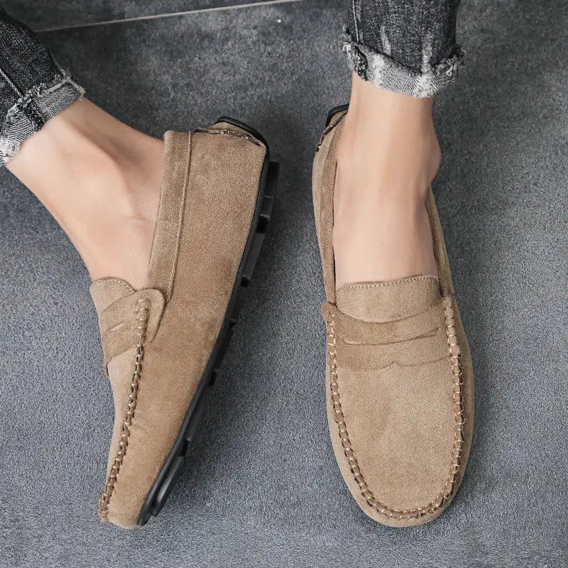 Pair of men's tan suede loafers; slip-on casual driving shoes with moc stitching.