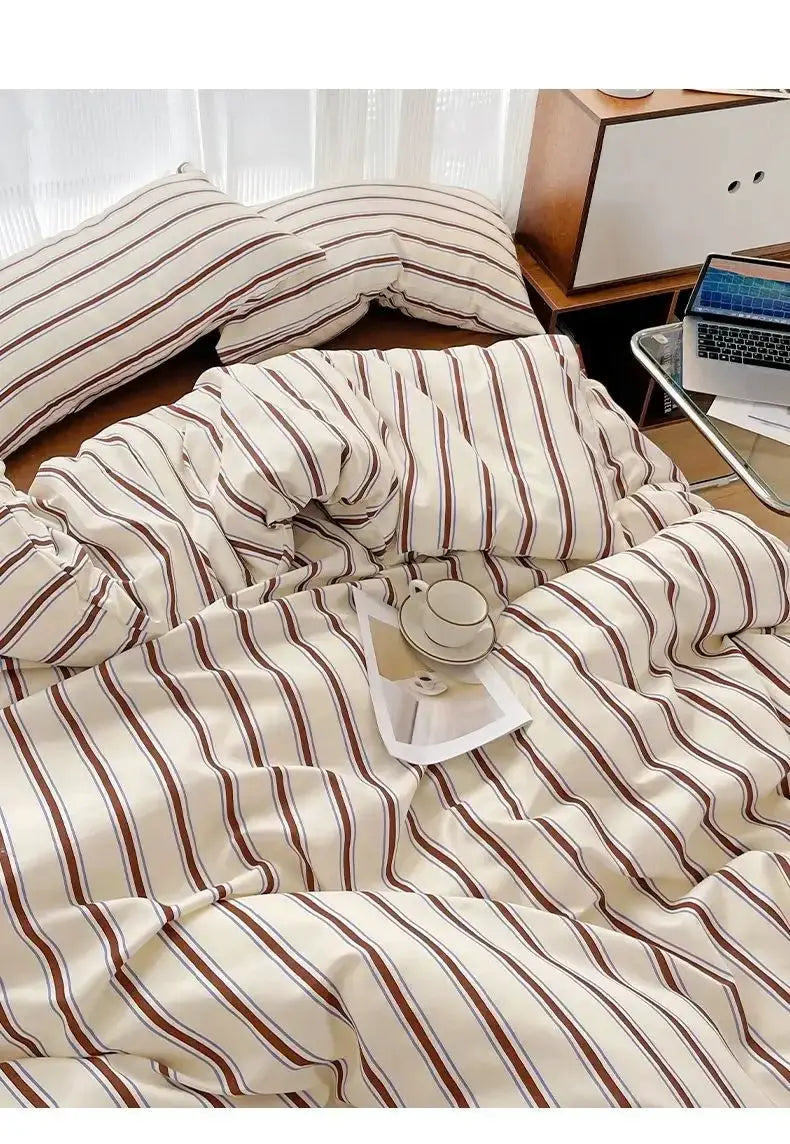 Striped duvet cover and four-piece washed cotton sheet set from Simples Market in cream with red and blue stripes