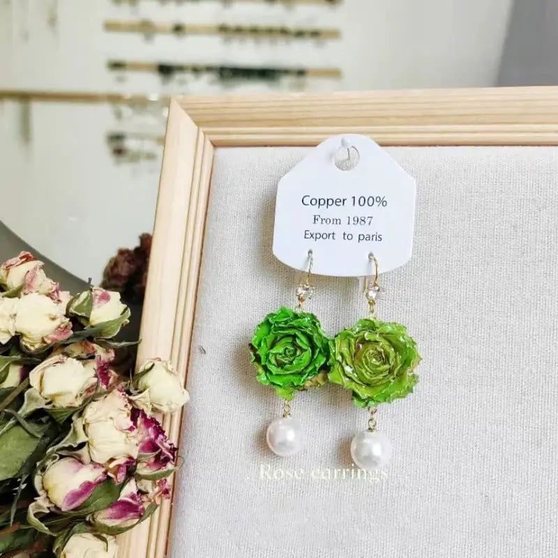 Elegant Immortal Rose Long Earrings; green epoxy rose pendants with pearl drops on gold-tone chains