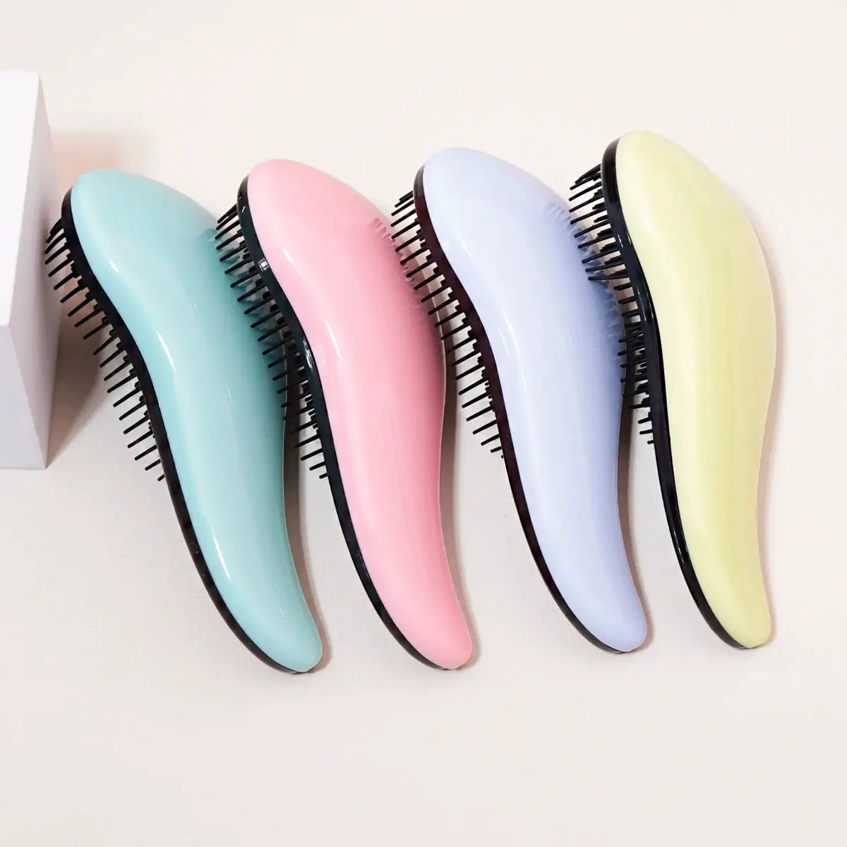 Antistatic massage brushes, 4-pack by Simples Market, in pastel teal, pink, lavender and yellow with black bristles
