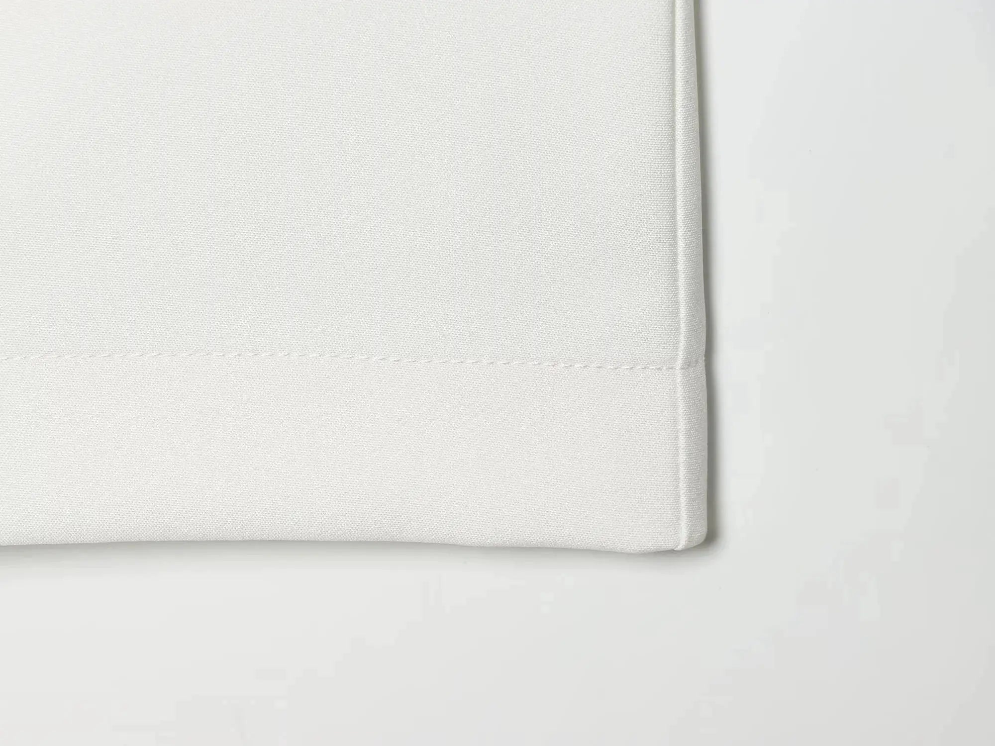 KONDALA white blazer fabric close-up with textured weave and stitched edge.