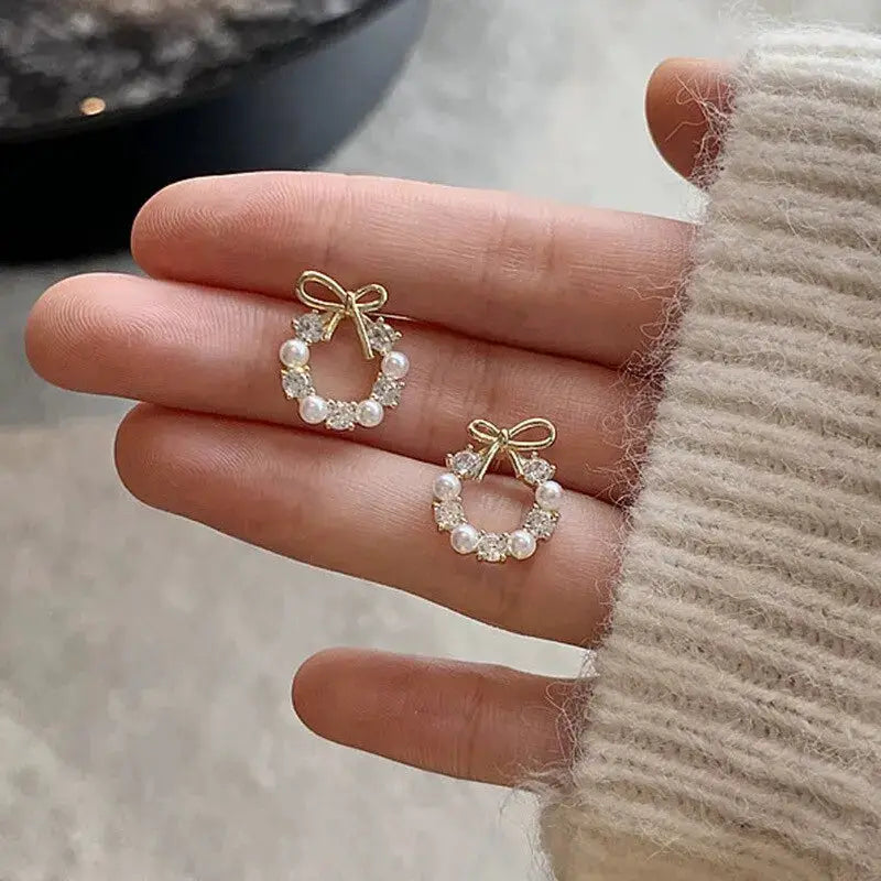 Hollow-out round rhinestone bow stud earrings pair for women with imitation pearls, gold-tone finish