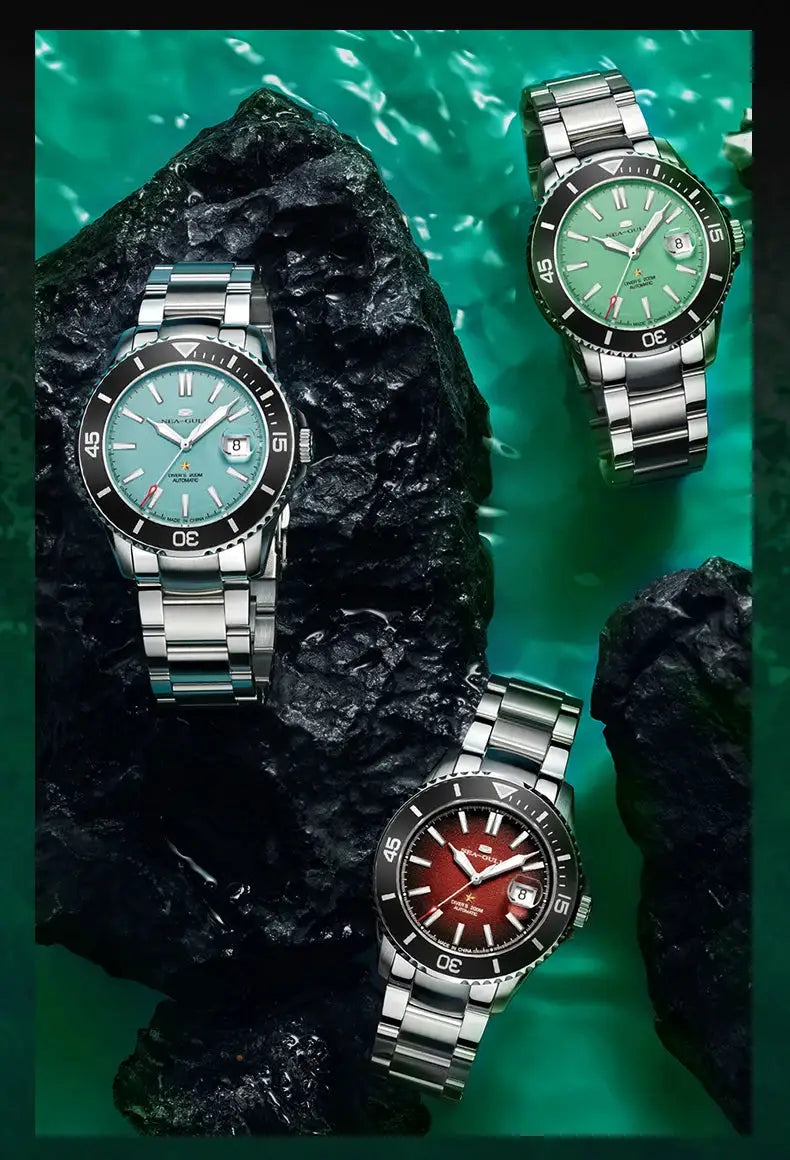 Seagull men's diving watches, 3 stainless steel timepieces with blue, green and red dials on rocks