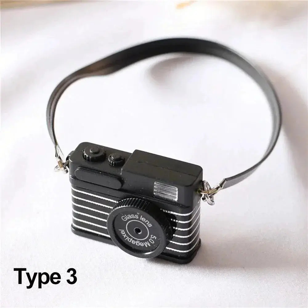Dollhouse miniature digital SLR camera (1/6 scale) by Simples Market, black with strap