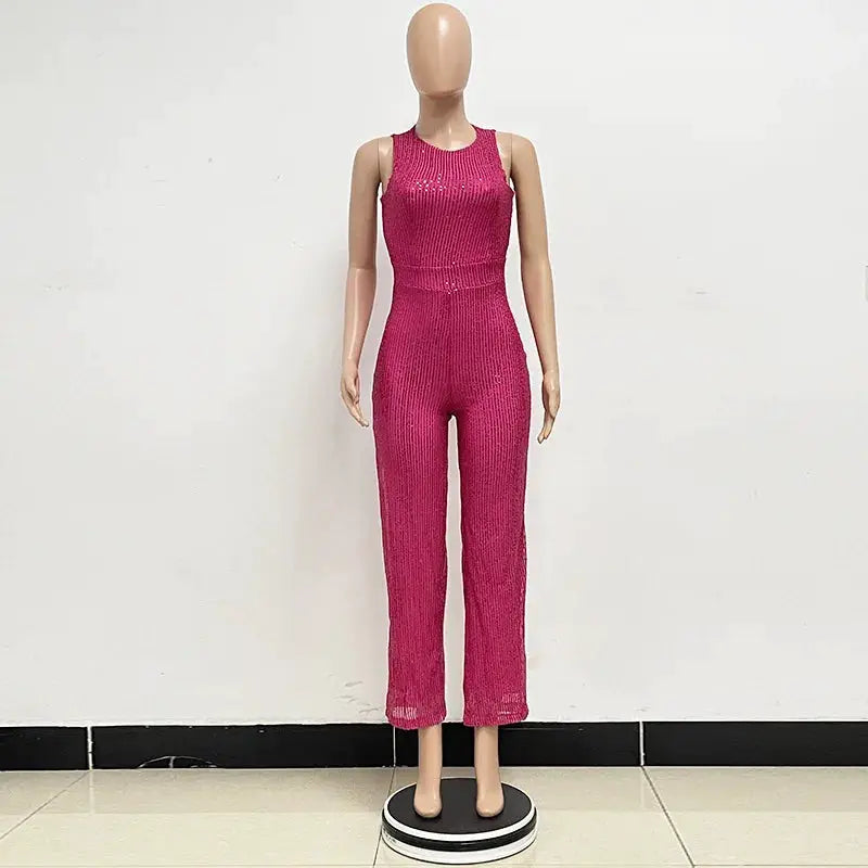 Women's pink sequin jumpsuit, sleeveless, high-waist, fitted glam look.