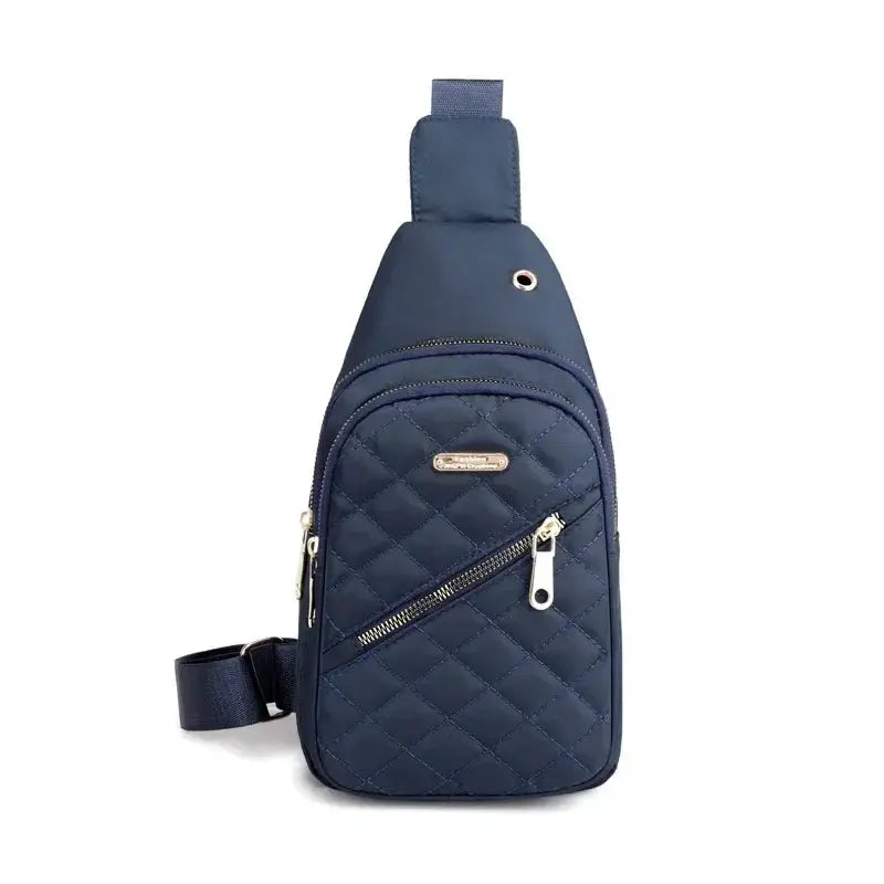 Sling bag by Simples Market, navy quilted fabric with gold zippers and front diagonal pocket