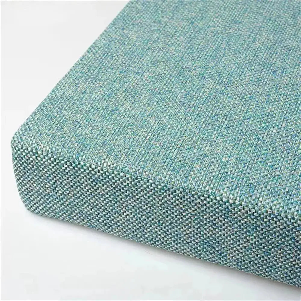 Square chair cushion in turquoise woven fabric with a machine-washable cover.