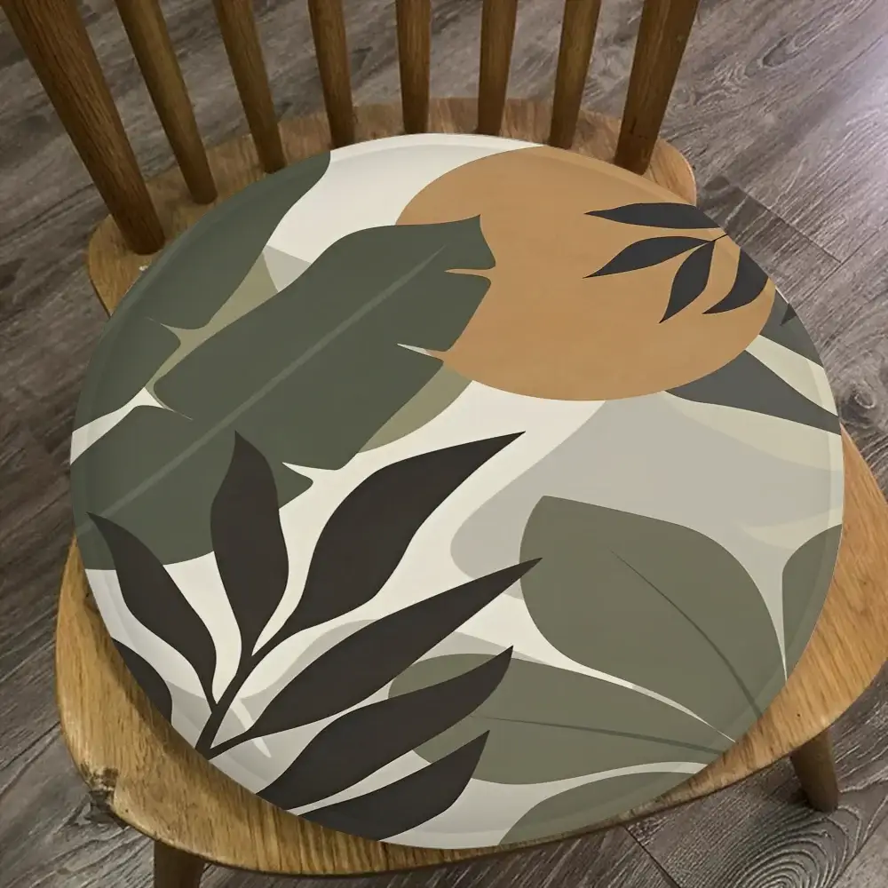 Round palm-leaf chair cushion with botanical print in olive green, beige and charcoal; 45x45cm.