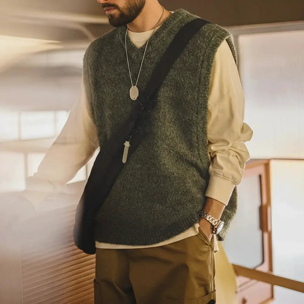 Maden retro wool-blend knitted V-neck vest; olive-green layered over a beige long-sleeve shirt.
